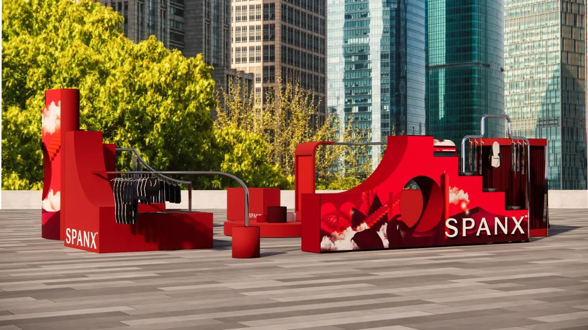 Rendering of a Spanx pop-up shop featuring black clothing and bright red curvy displays