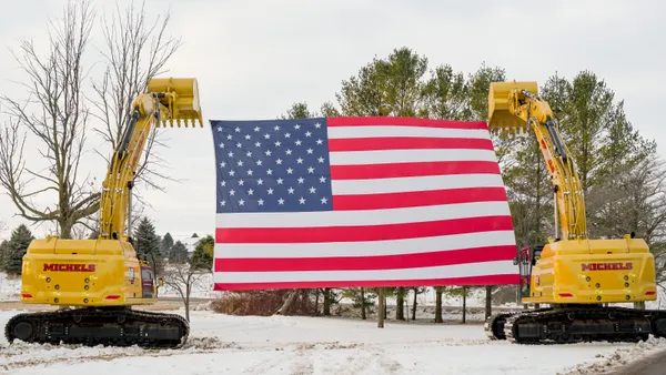 Construction machines hold up an American flag on the site of the $15 billion Lighthouse data center project