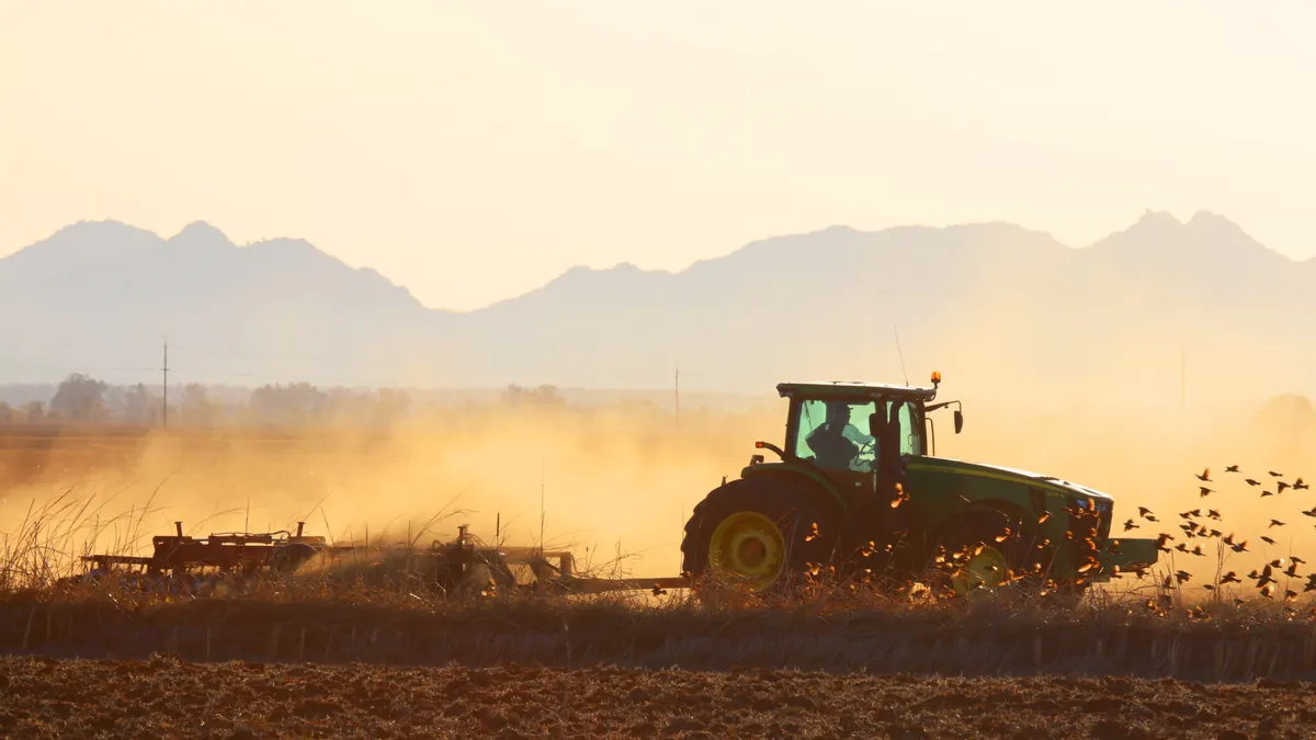Person on tractor in a rice field