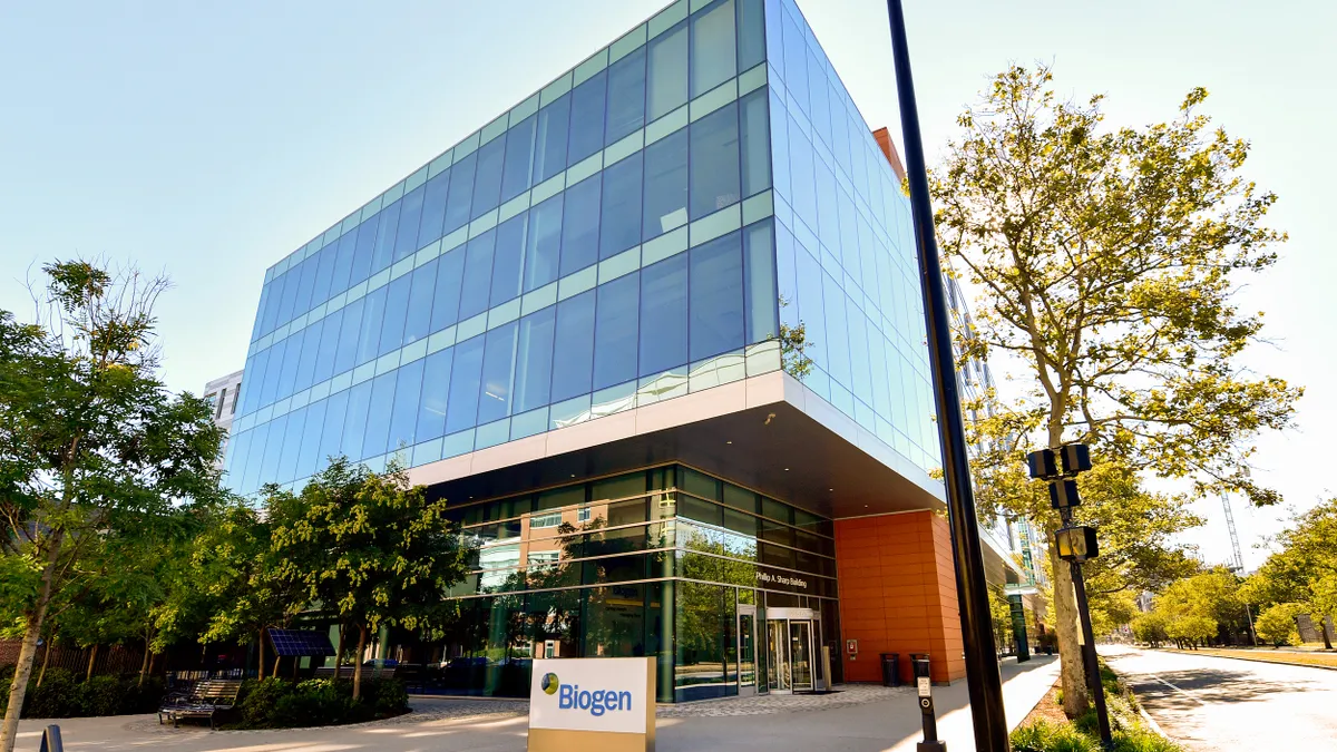 A glass building with a sign that reads,  "Biogen."