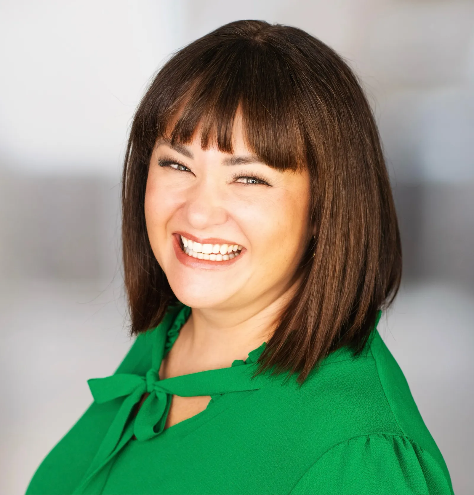 Tami Fisher, chief information officer at TAB Bank, wears a green blouse while posing for a photo.