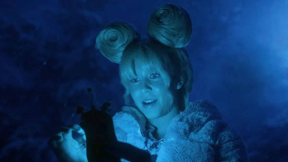 A Dr. Seuss-inspired character is bathed in the blue light of a mobile device in a holiday ad from Walmart