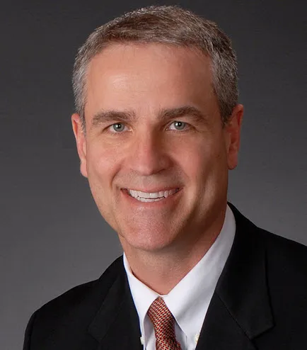 Headshot of man in suit and tie