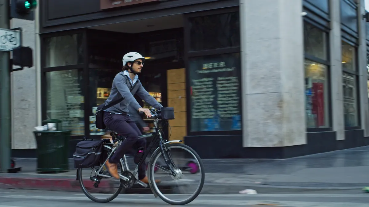 A man cycling to work on an e-bike in Downtown Los Angeles.