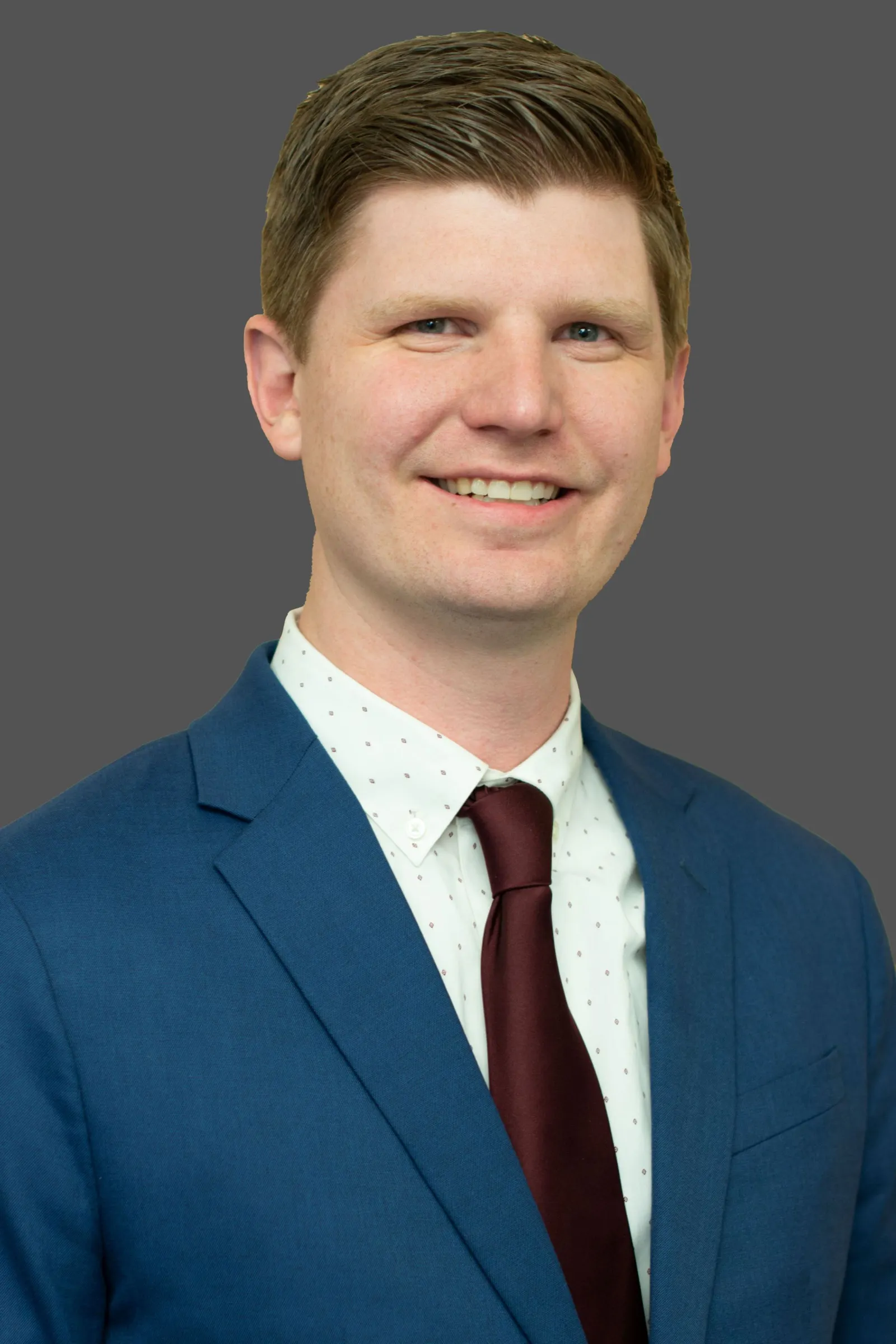 Headshot of a man in a suit.