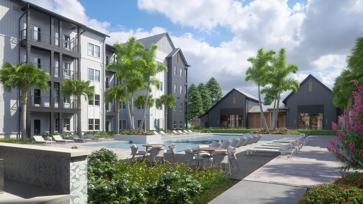 Grey, 40-stroy apartment with pool and palm trees in the foreground.