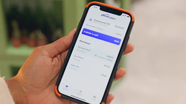 A hand holds a smartphone displaying the Affirm app.