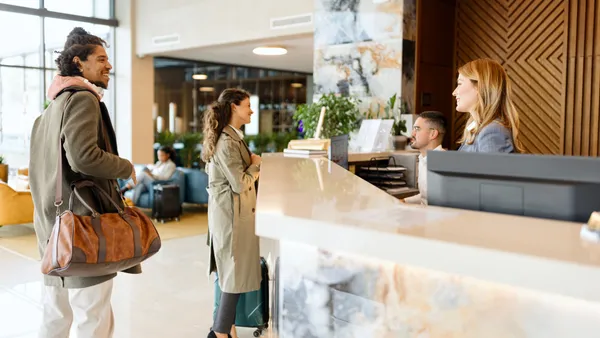 Travelers check into a hotel.