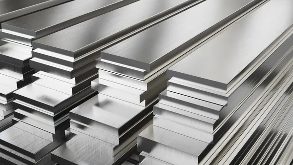 Stacks of shiny silver steel plates.