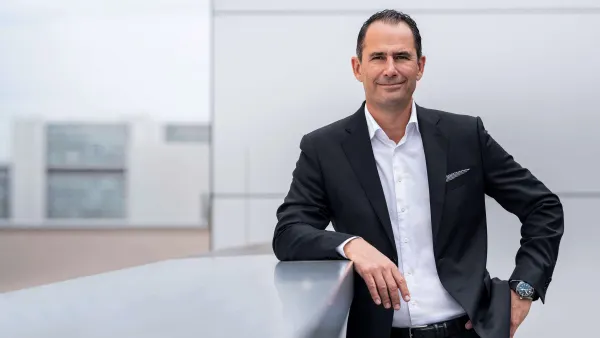 An executive photo of Volkswagen's new North America CEO Marco Schubert wearing a black suit without a tie.