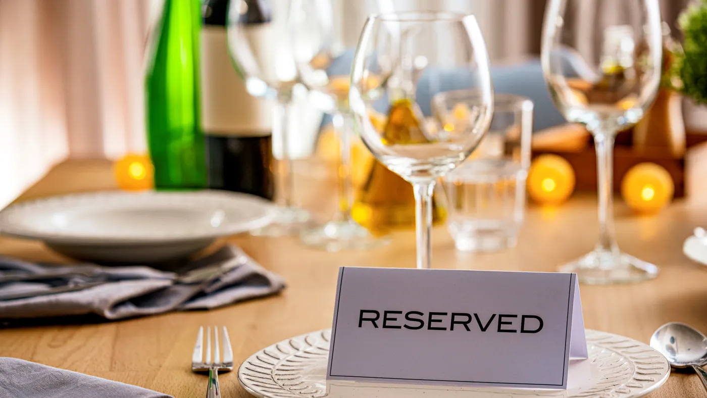 A sign on a table declaring it to be reserved.