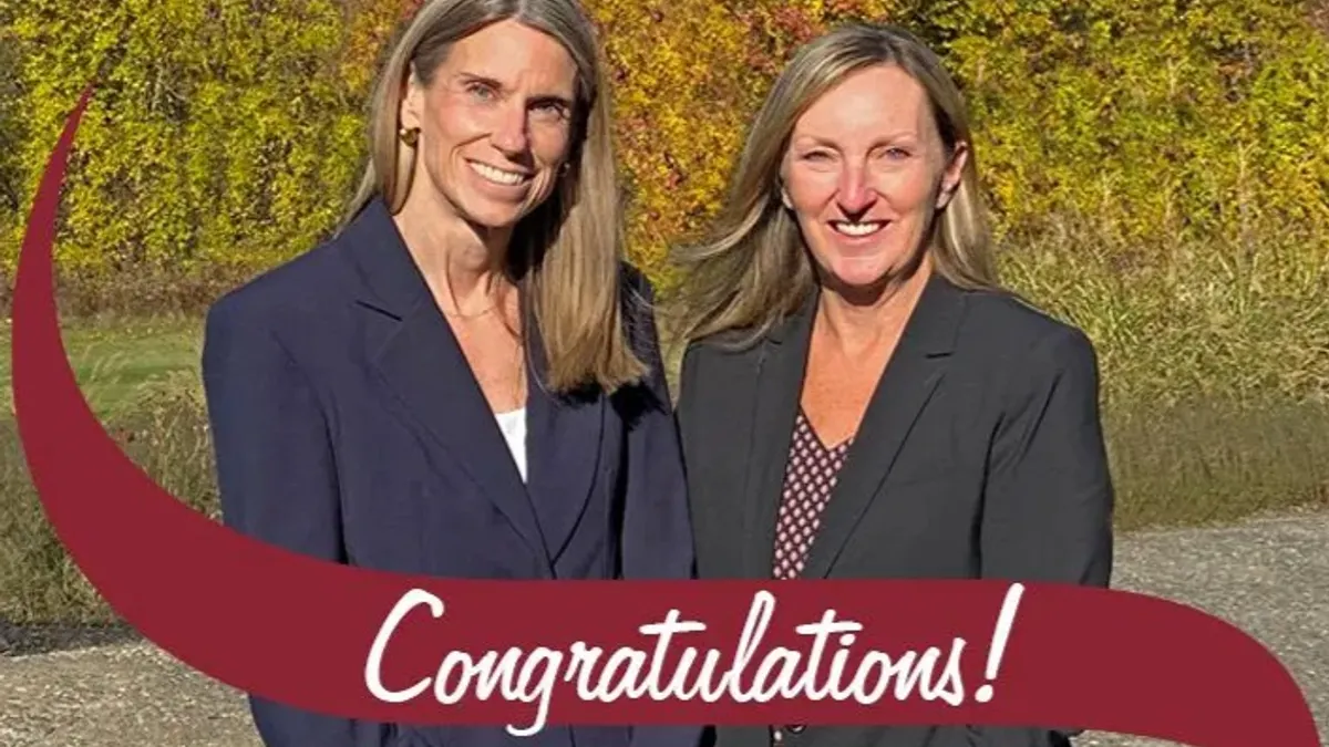A photo of two people standing outside. White text on a maroon background says "congratulations."