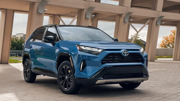 An exterior view of a blue 2025 Toyota RAV4 hybrid SUV.