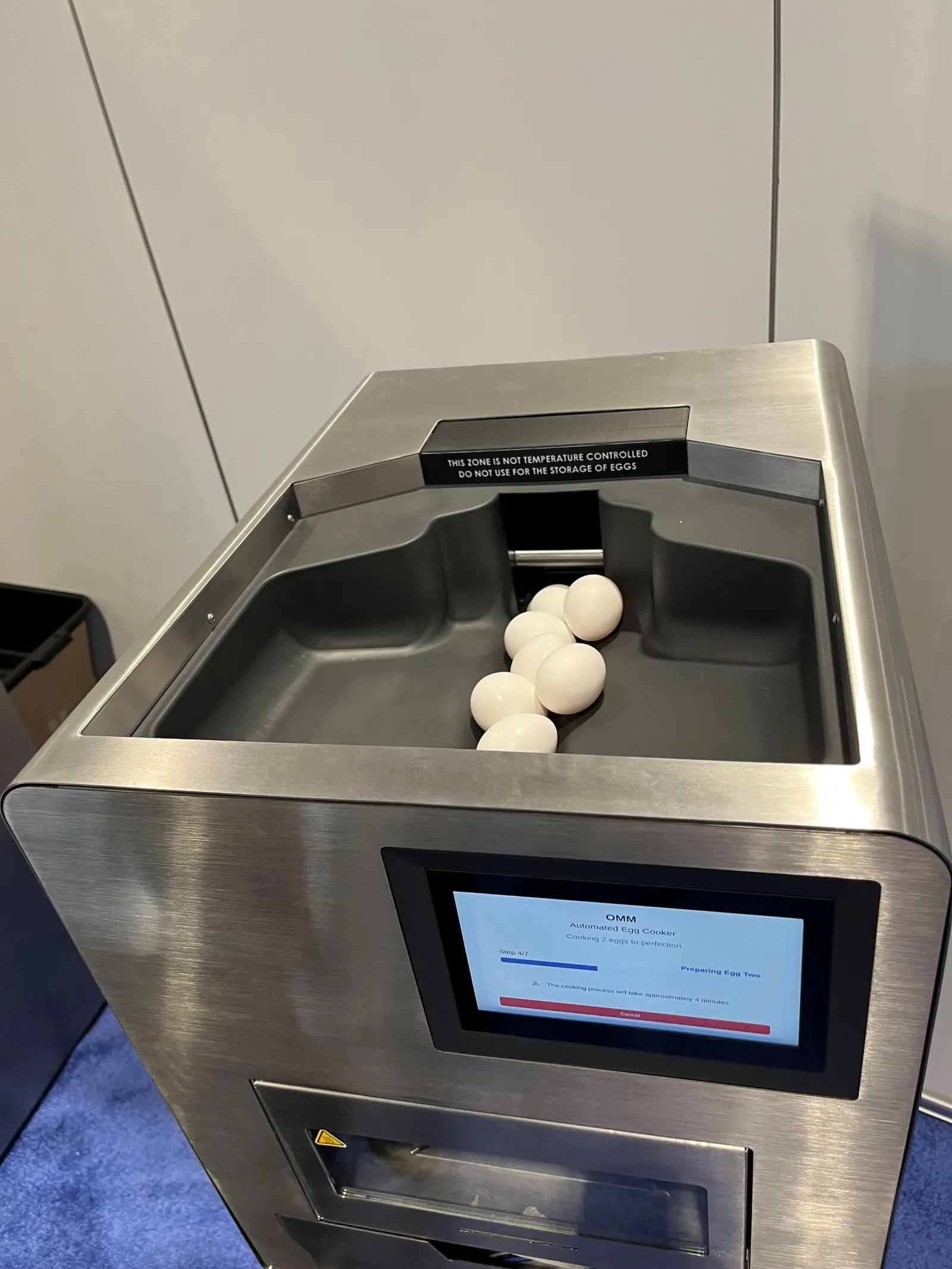 Eggs in a plastic hopper on an automated egg cooker.