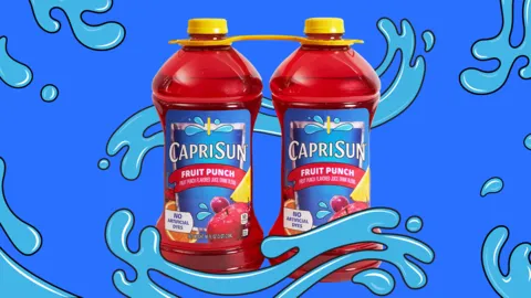 Two large bottles of Capri Sun fruit punch flavored beverage.