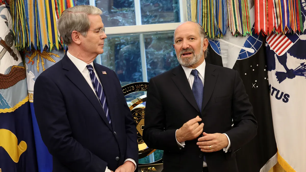 U.S. Commerce Secretary Howard Lutnick (right) speaks with U.S. Treasury Secretary Scott Bessent (left) in the Oval Office of the White House on Aug. 6, 2025, in Washington, D.C.