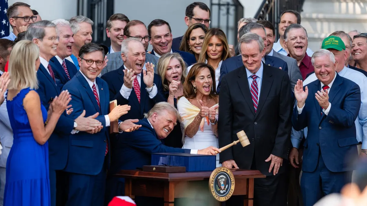 U.S. President Donald Trump, joined by Republican lawmakers, holds a gavel after signing the "One, Big Beautiful Bill" Act into law during an Independence Day military family picnic on the South Lawn of the White House on July 04, 2025 in Washington, DC.