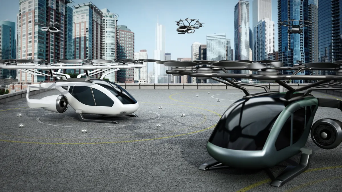 Two futuristic air taxis (eVTOL aircraft) on a rooftop heliped with one flying among large skyscrapers in the backround.