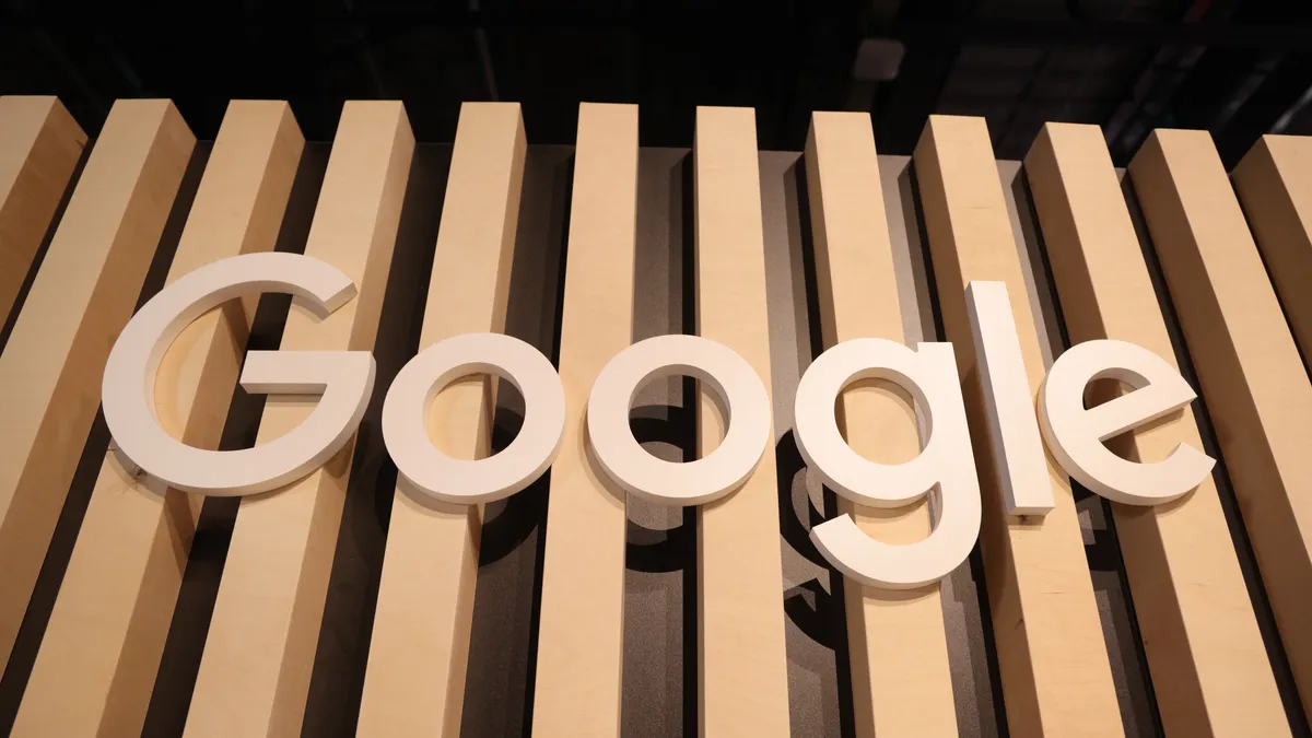 A wooden Google logo hangs at a stand at the 2022 Re:publica digital society festival on June 09, 2022 in Berlin, Germany.