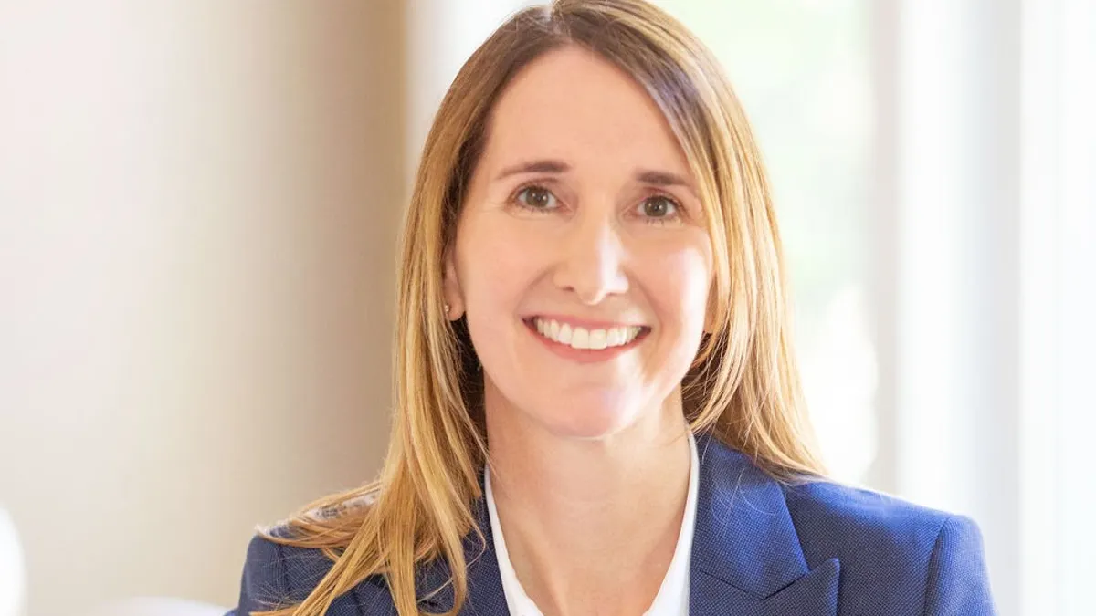 A photogrpha of a person smiling at the camera