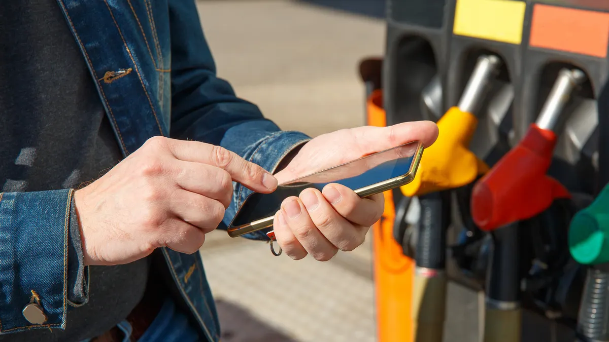 A smartphone being used to pay at a fueling station.
