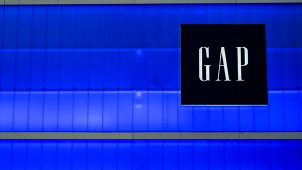 A storefront sign titled "Gap" sits against a blue window background