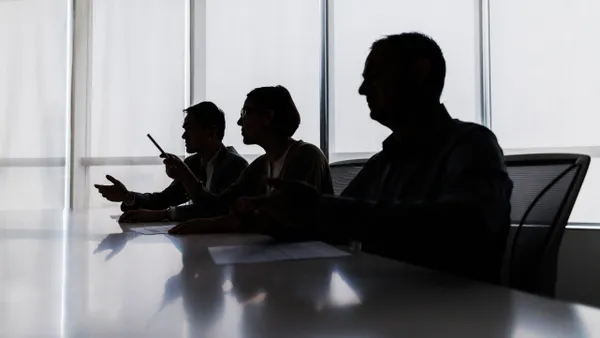 Silhouette of business people negotiating at meeting table