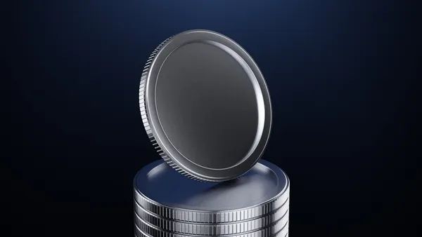 Stacked silver coins with a single coin spinning above on a dark gradient background, symbolizing finance, savings, investment and economic motion in a minimalist studio composition conveying wealth and growth.
