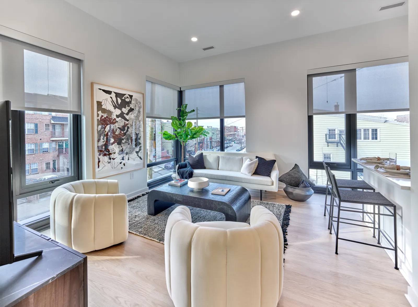 An apartment living room with lots of furniture.