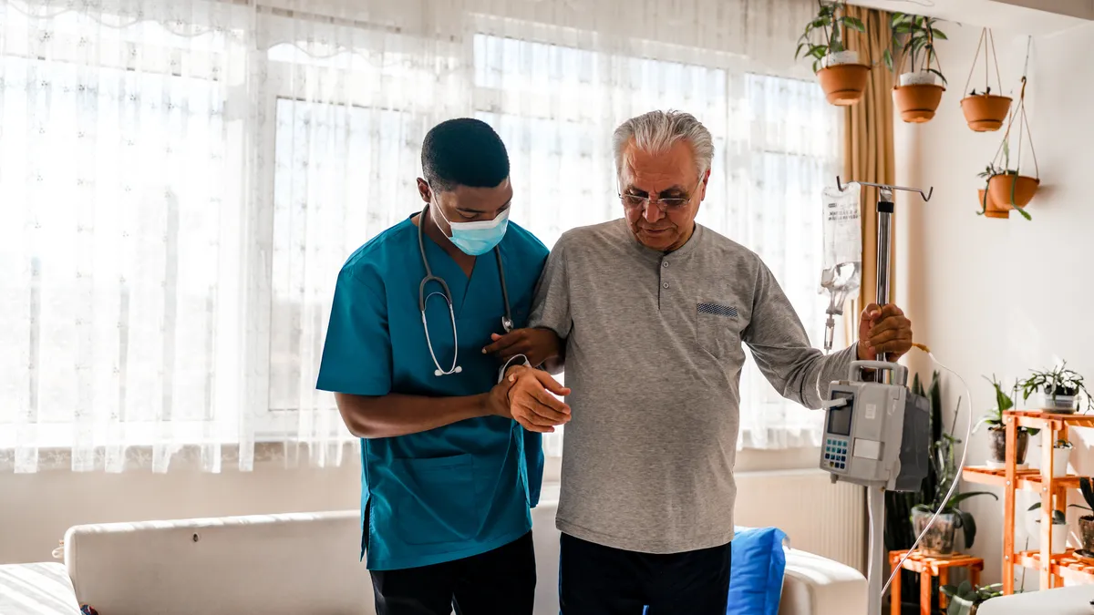 A man being helped by a home health care aide