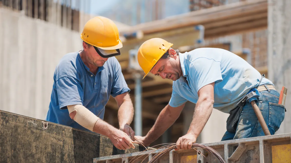 Two construction workers are working.