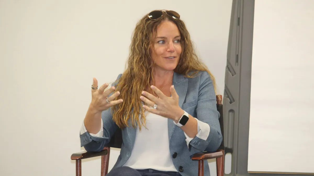 a woman speaks on a panel