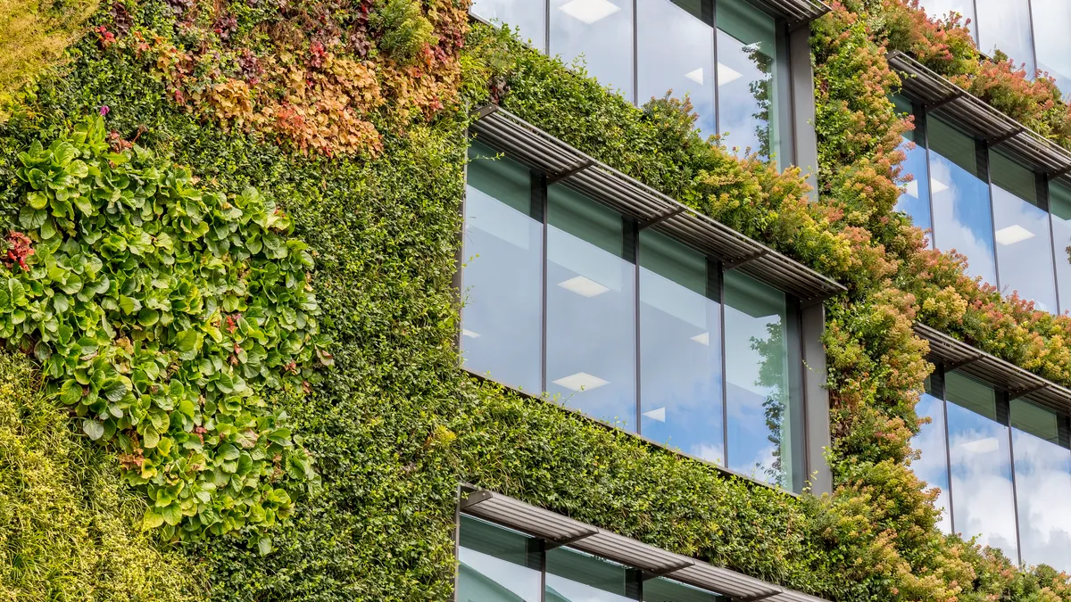 A building with vegetation growing along the sides.