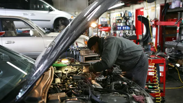 A technician works on a car.