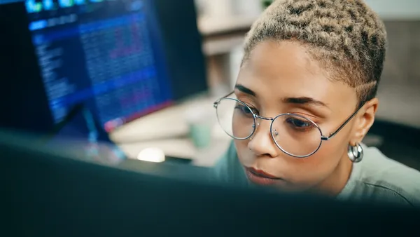 Computer, cyber security and face of woman programming ERP software, cybersecurity system or algorithm code. Programmer, developer or coding machine learning cloud computing server or IT database