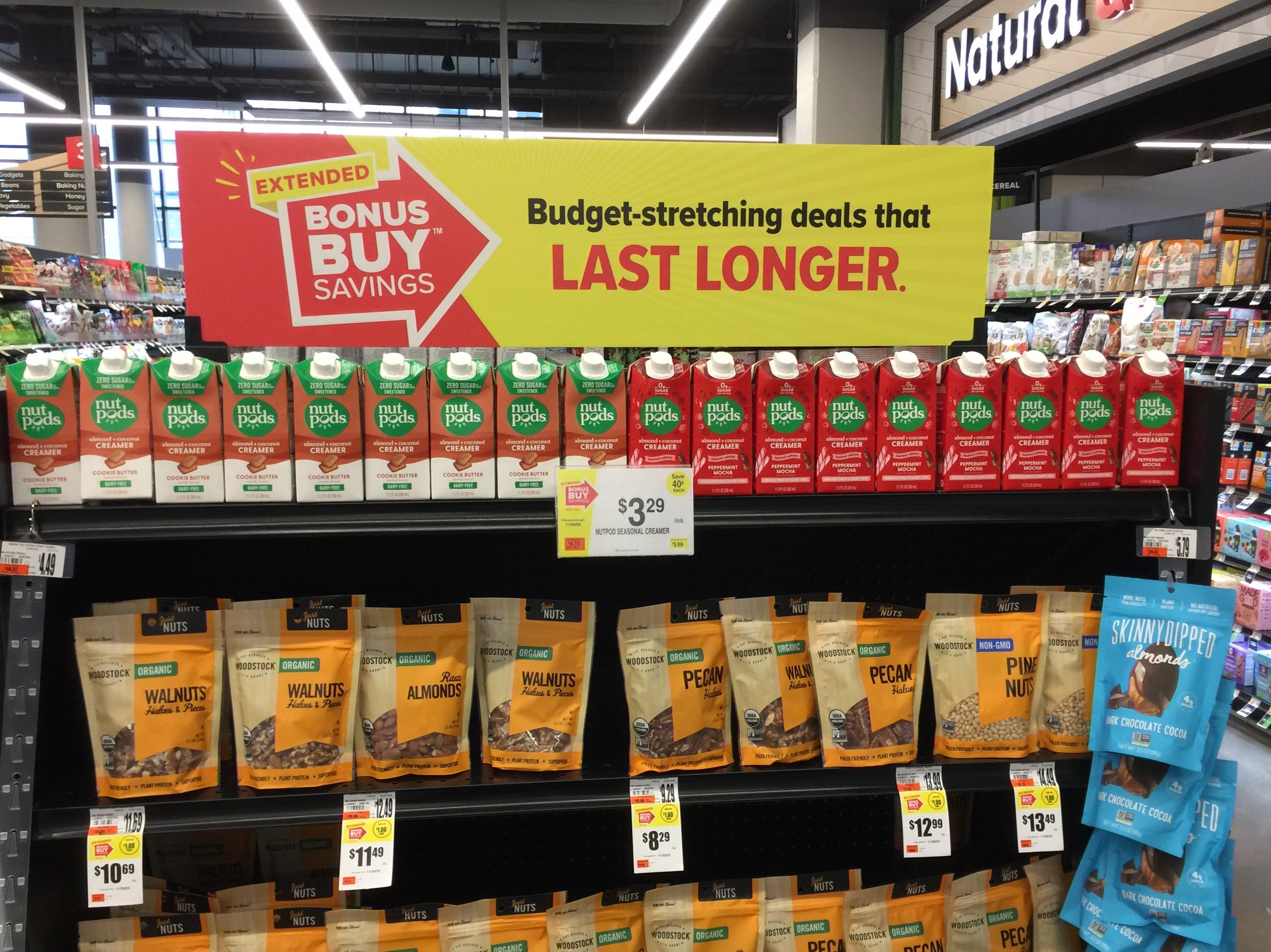 Sign about discounts above items on grocery store shelves