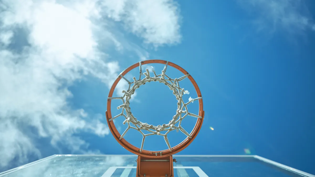 Cropped shot of a basketball net on a sunny day outside.