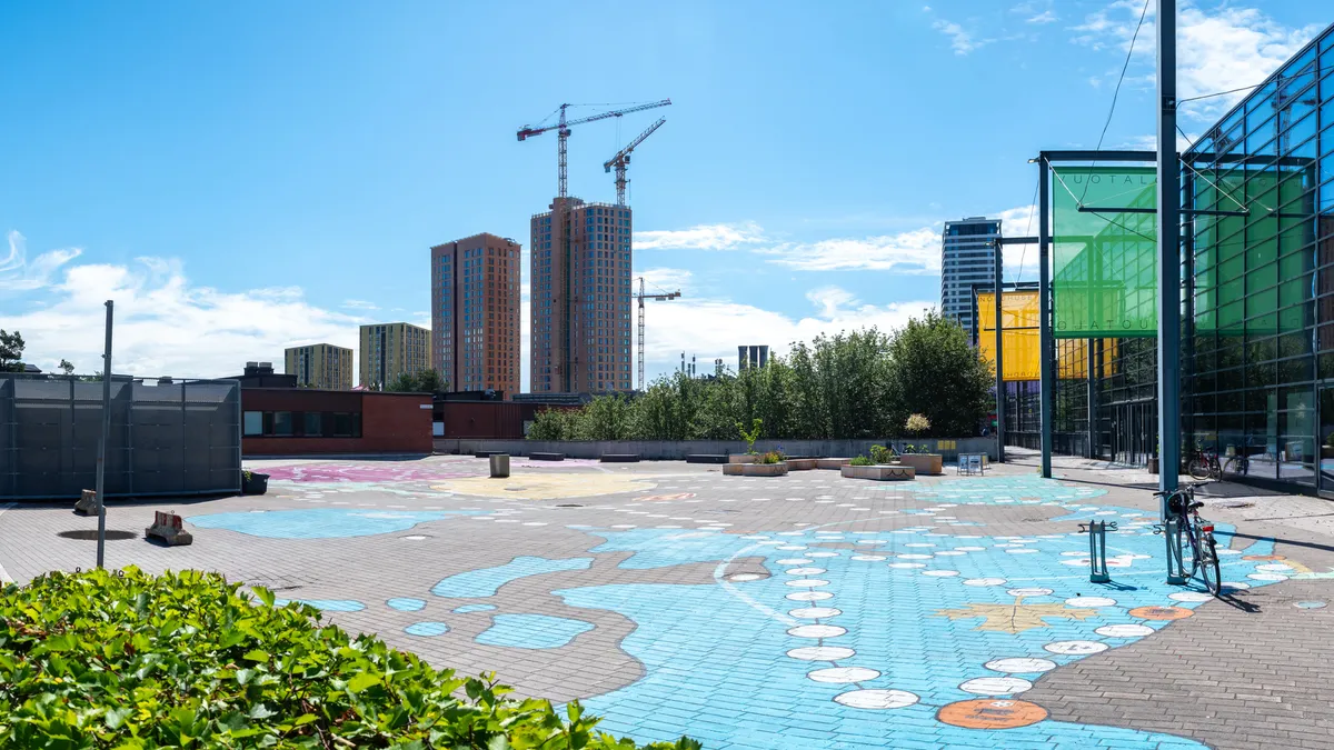 Asphalt art in open plaza in front of buildings