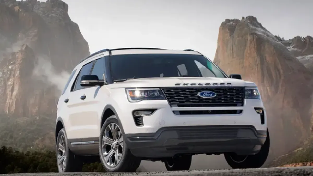 A white 2018 Ford Explorer SUV shown outdoors with mountains in the background.