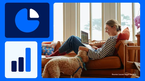 Person sitting on a couch with their laptop on their lap and petting a dog.