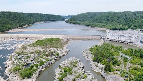 An aerial view of a hydroelectric dam on a river.