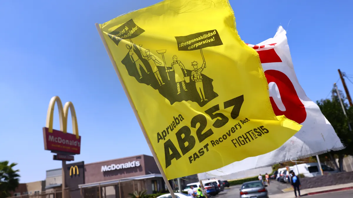 Two flags flown by fast food workers demonstrating in support of AB 257.