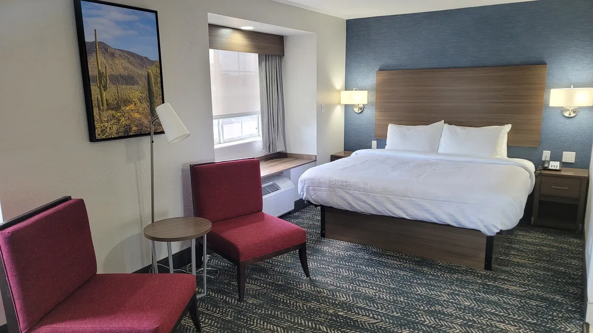 A guest room with bed and chairs at a Best Western hotel in Arizona