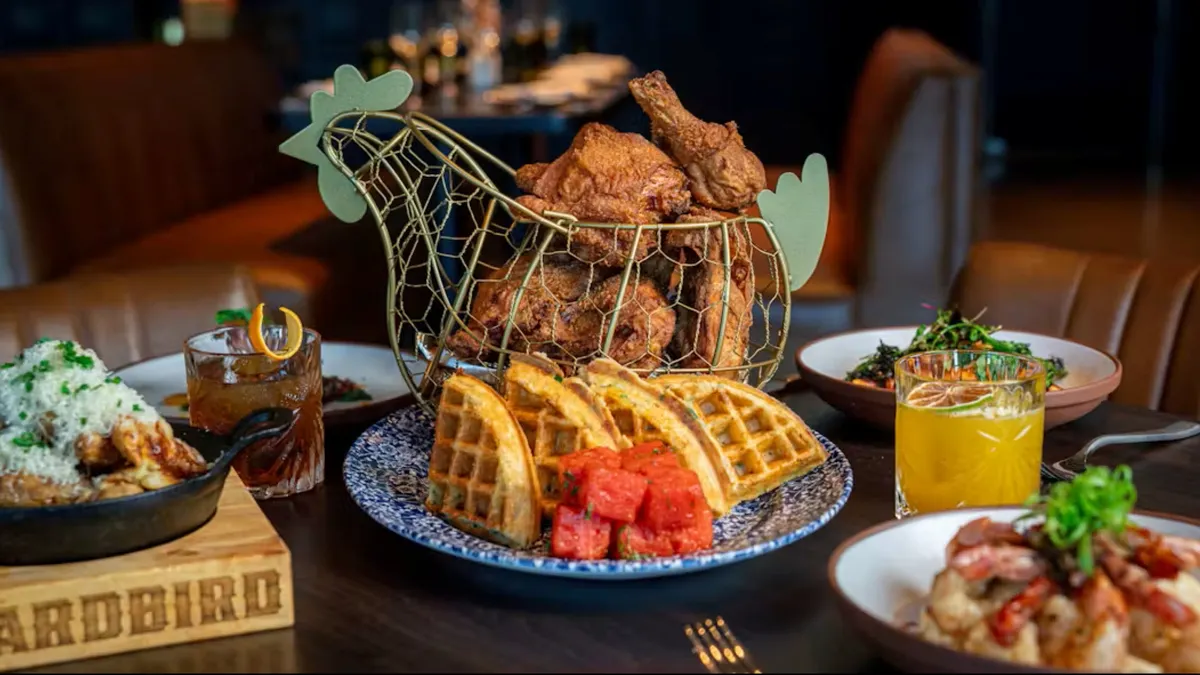 A basket of fried chicken and some other food.