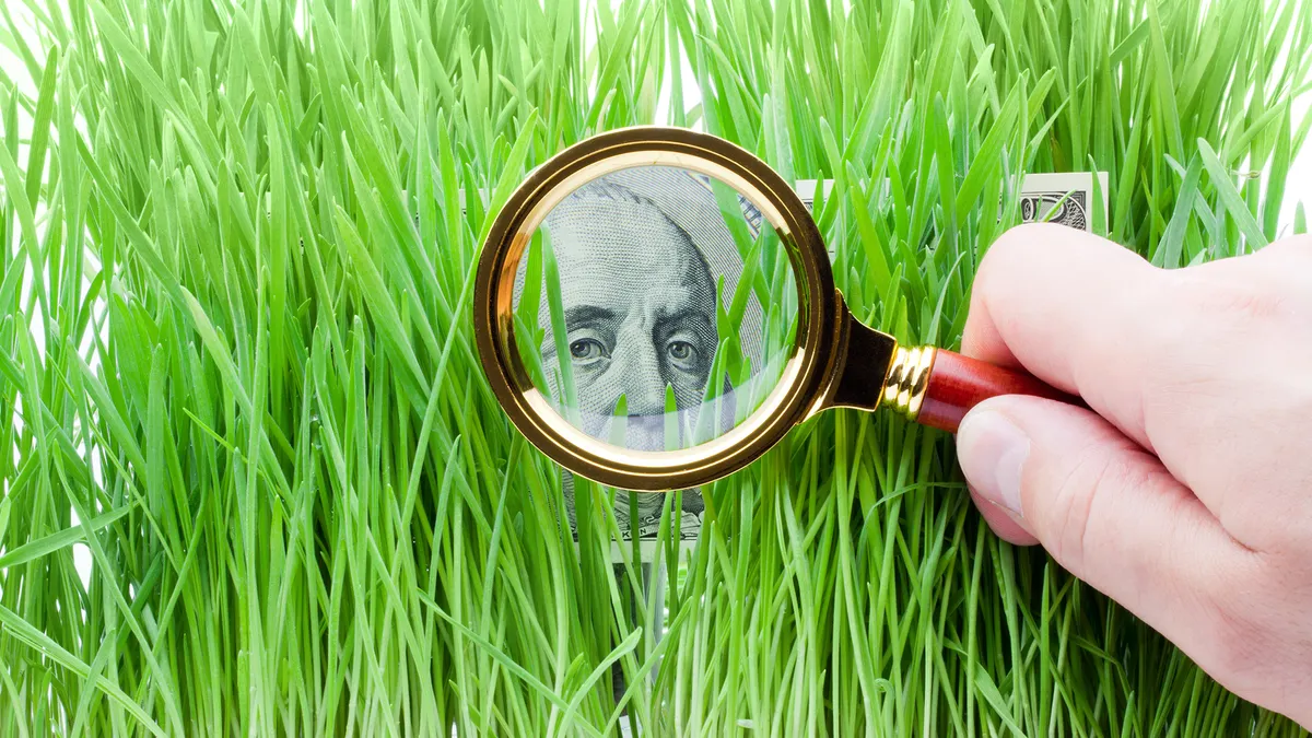 Magnifying glass searching through grass