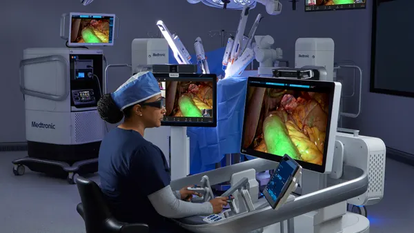 A physician sits at the console of Medtronic's Hugo robotic surgery system.