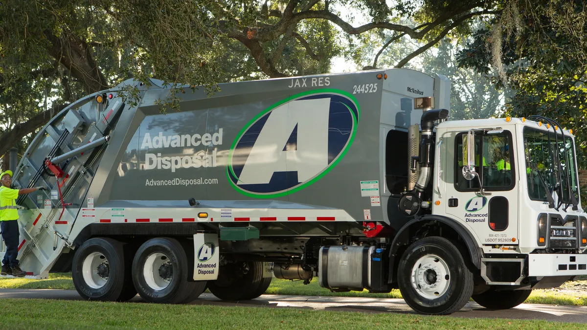 Advanced Disposal Services truck with helper on back