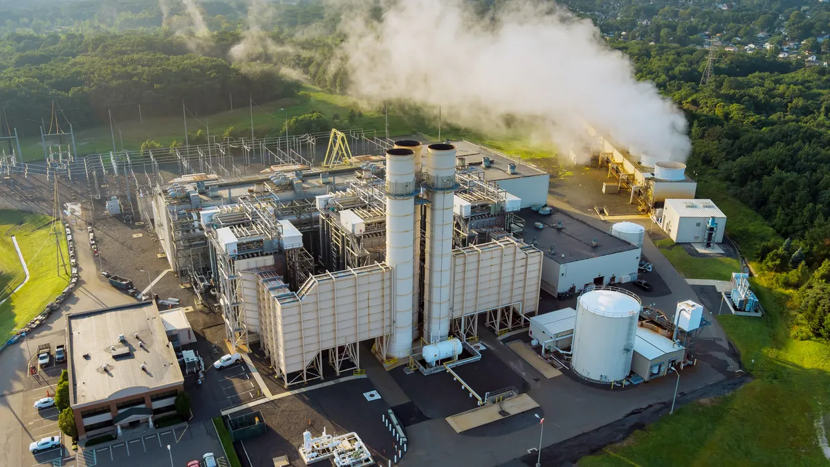 Energy thermal power station roof plant with white smoke cloud.