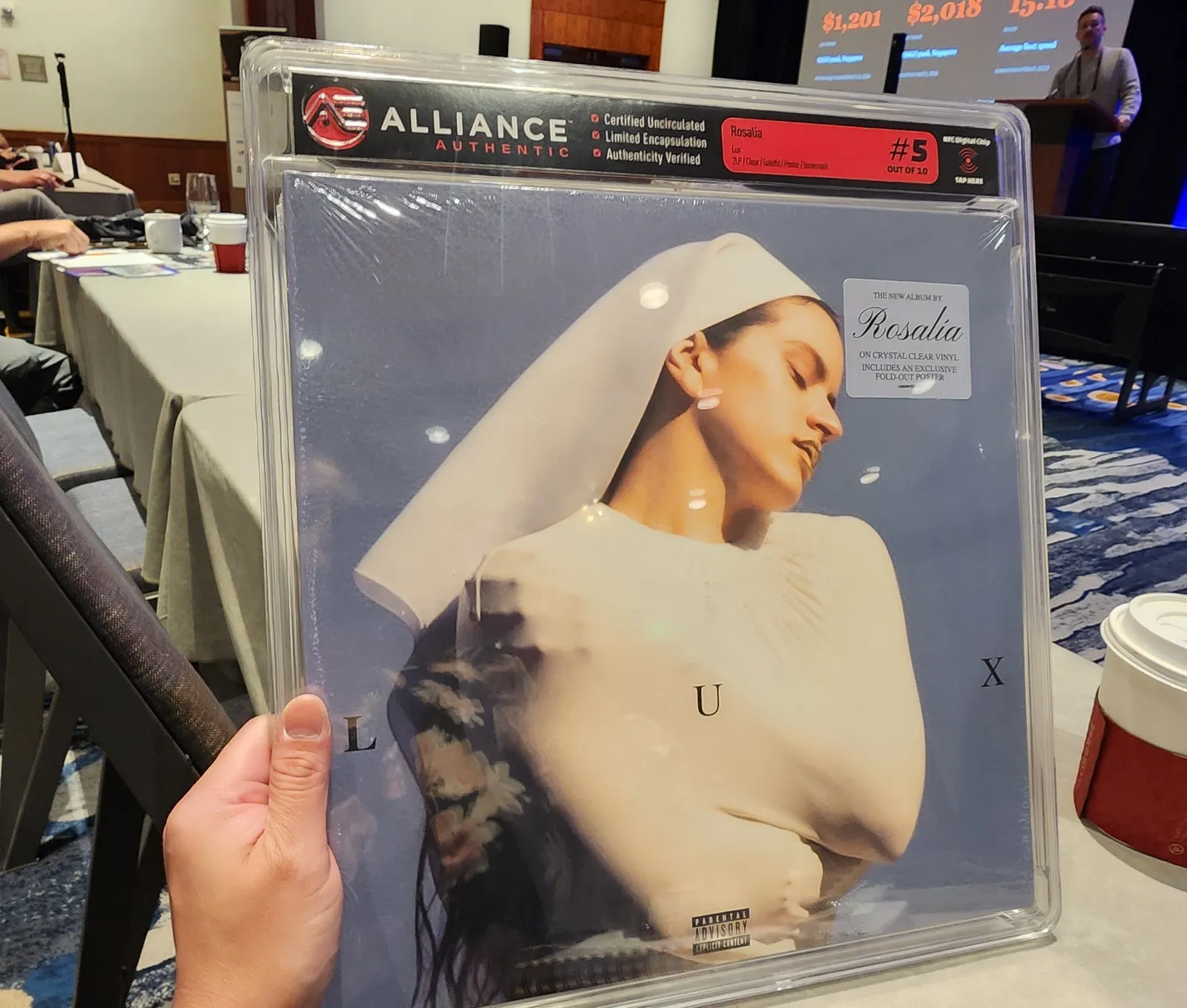 A clear plastic package containing a vinyl record Rosalía's "Lux" album.