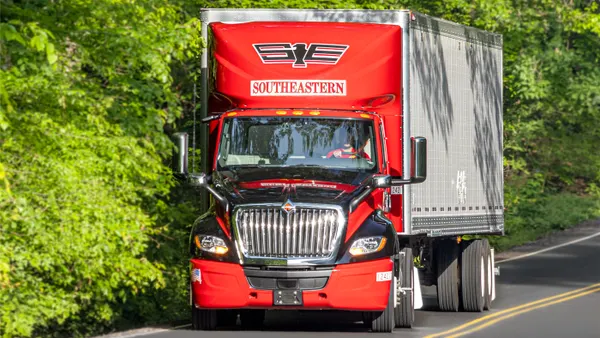 A driver with Southeastern Freight Lines equipment faces directly at the camera.